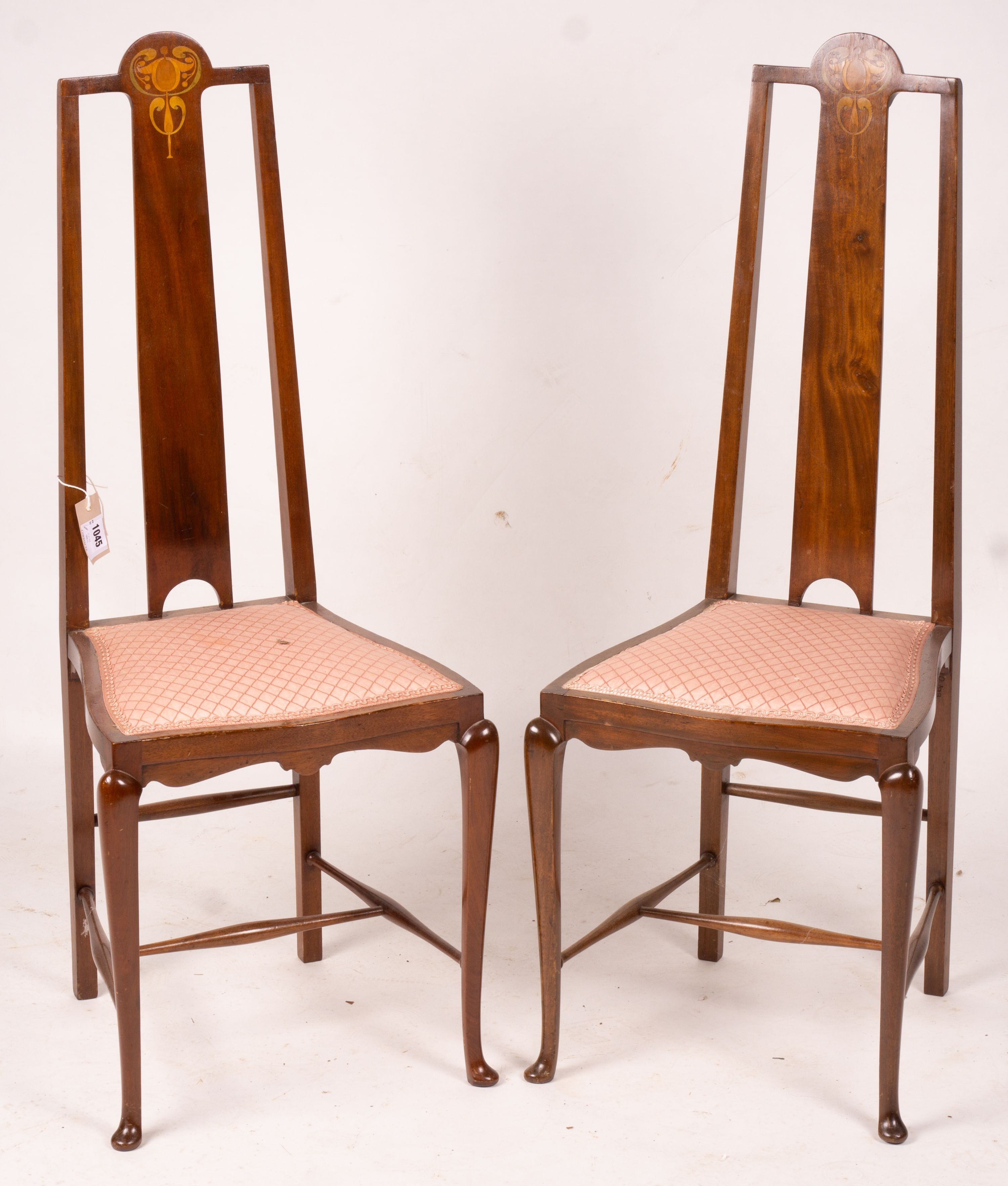 An Edwardian Art Nouveau inlaid mahogany towel rail and a pair of matching salon chairs (3)